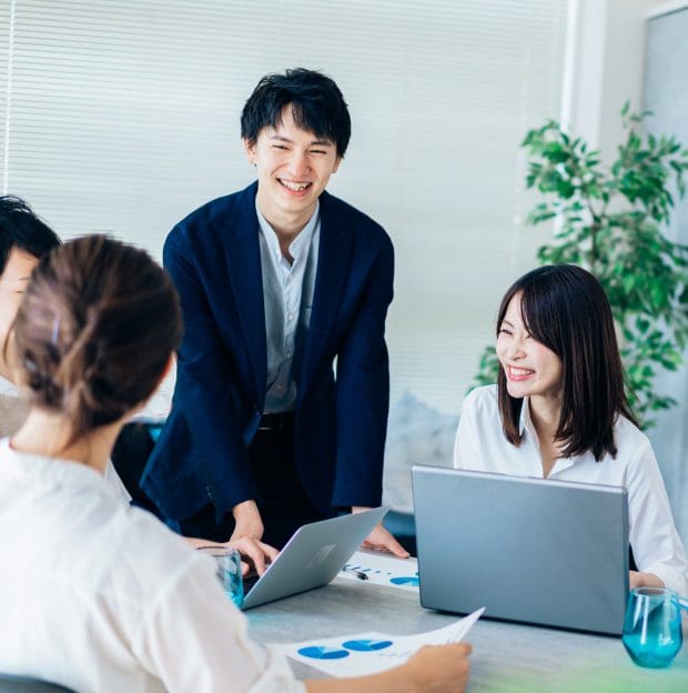 People smiling during a business meeting.